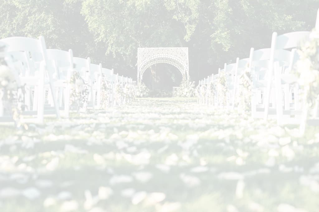 Outdoor wedding ceremony aisle with white chairs and floral arch — Southern Oak Events