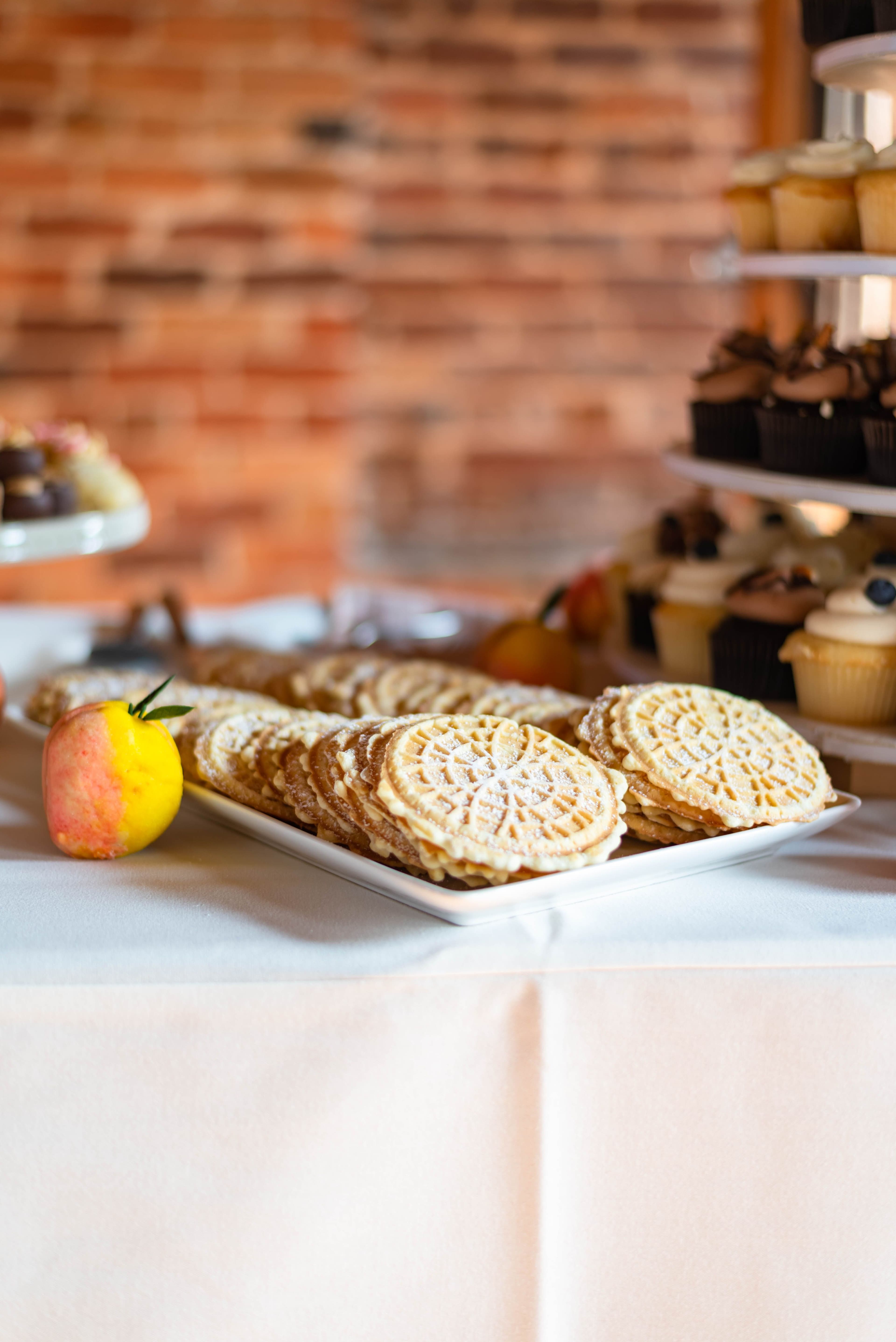 A platter of pizzelle cookies at a wedding cookie table — Photo by Reg and Kala Photography